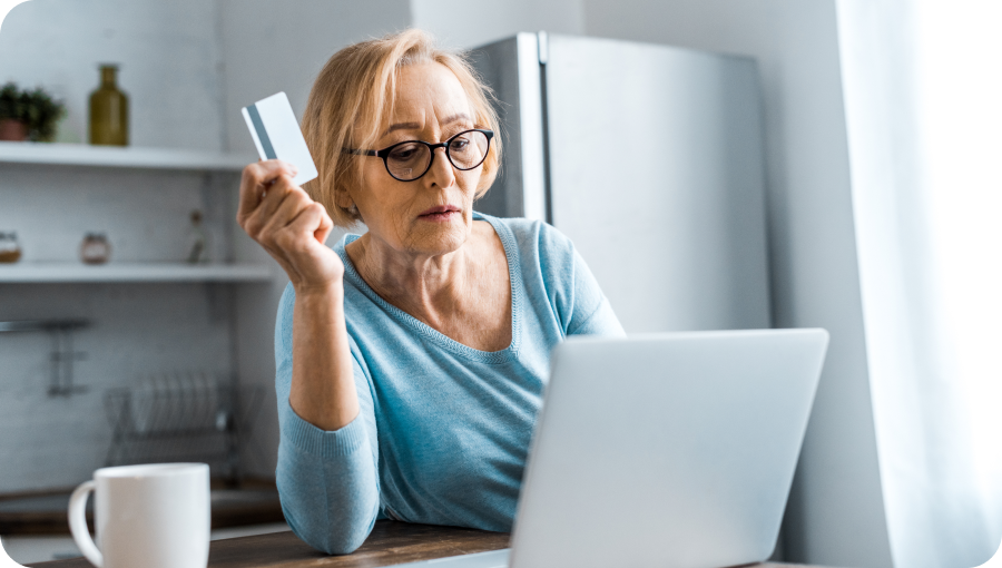 senior-woman-in-glasses-holding-credit-card